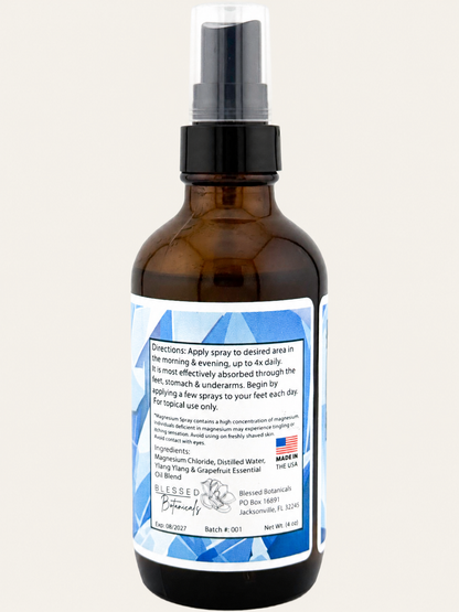 Blessed Botanicals Magnesium Spray with magnesium chloride, distilled water, and ylang ylang grapefruit essential oil blend in 4 oz amber glass spray bottle